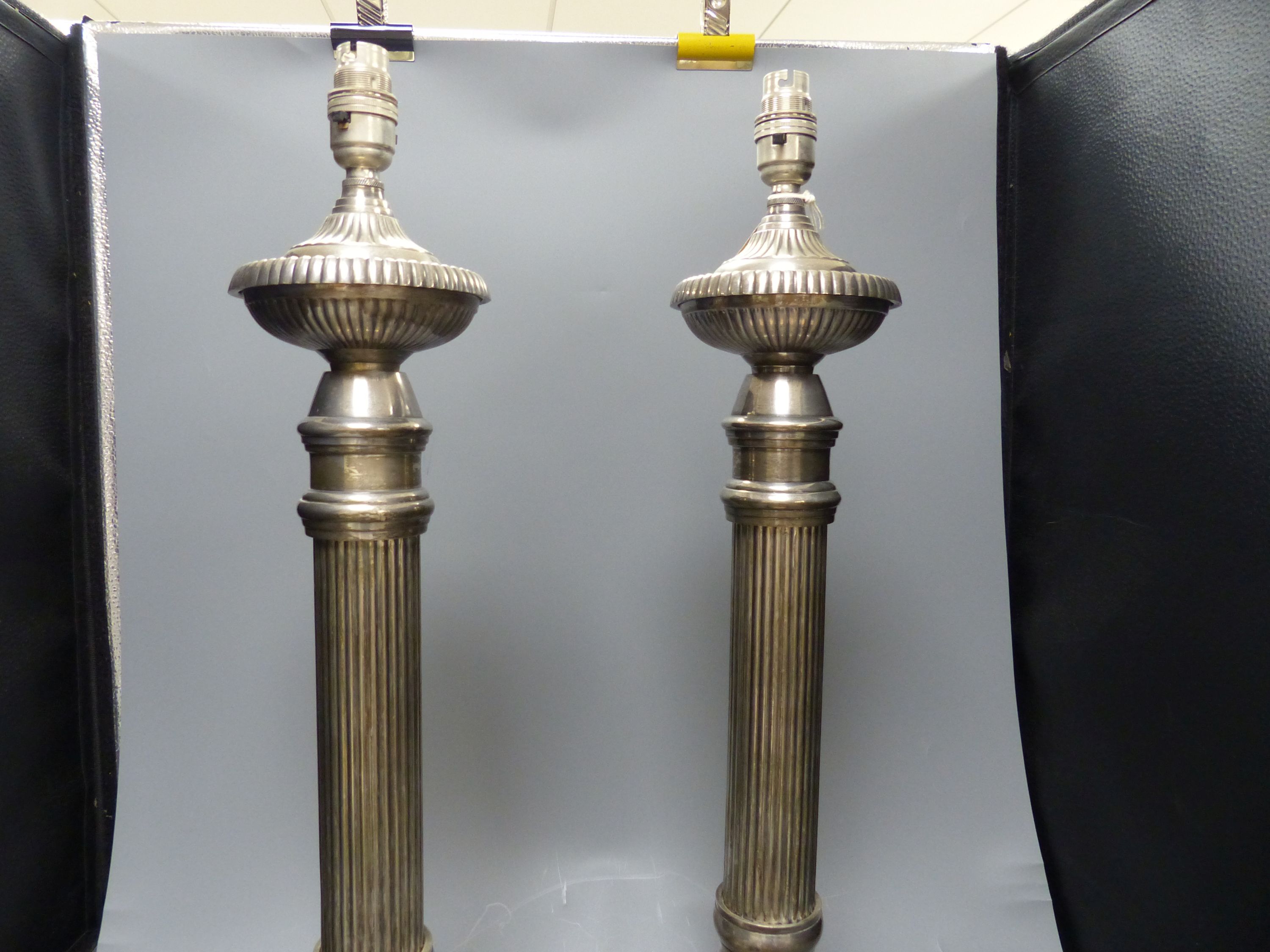 A pair of large plated electric table lamps, each square base marked AWEP, and a plated cake basket